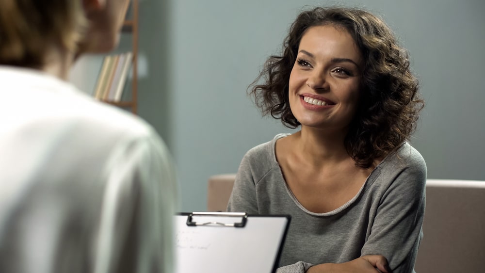 Young smiling lady at rehab therapy session