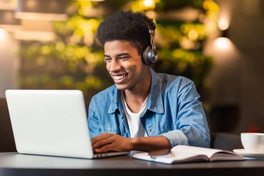 Teen on Laptop, Sitting in Headphones